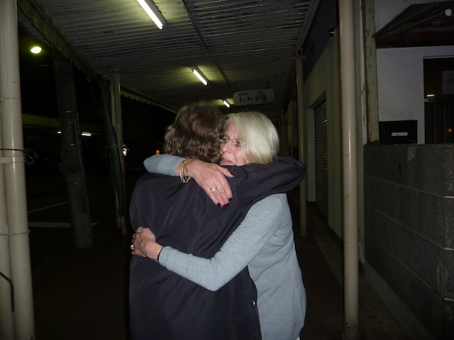 Hilary and Peter Waddington hugging in street