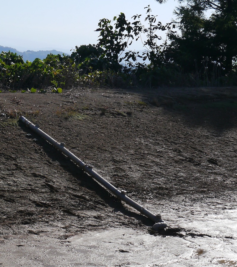 water drains outside the pond and down the mountainside.